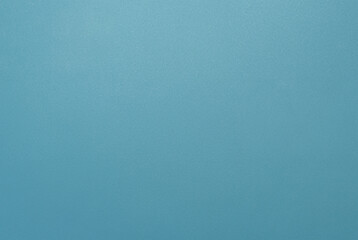 Simple minimalist blue textured background with a smooth surface, perfect for design projects.