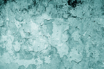 Peeling paint on grungy plaster wall. Cyan style.