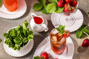 Refreshing summer drink with strawberries and mint being prepared to be served