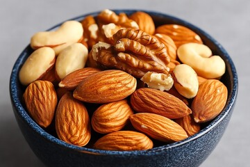 Realistic image of a bowl of mixed nuts including almonds, walnuts, and hazelnuts, showcasing their antioxidant properties and heart health benefits