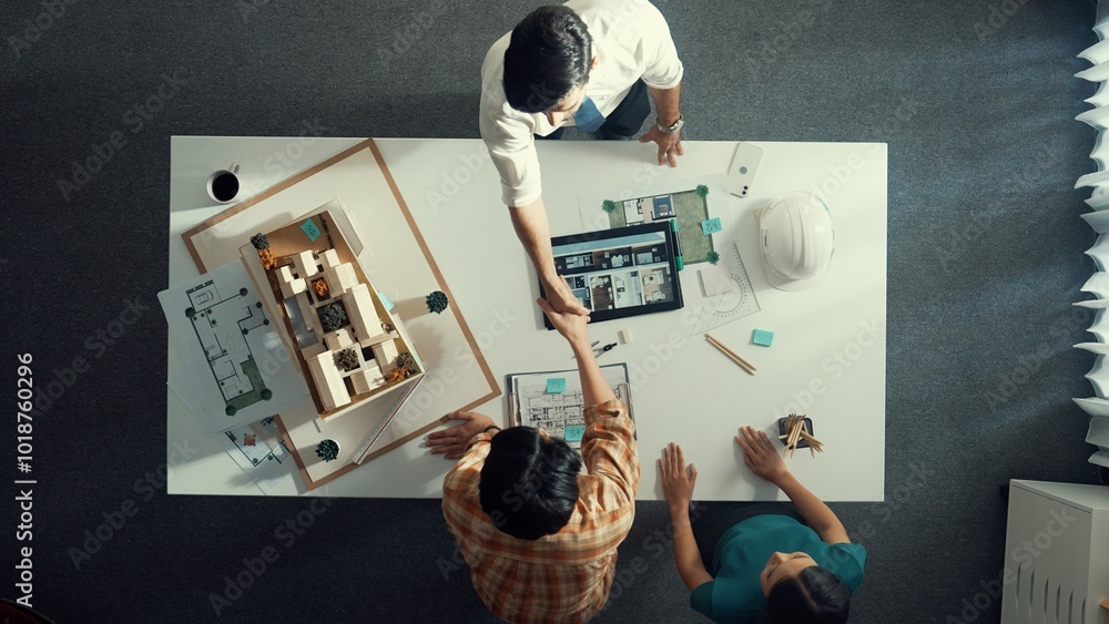 Poster top view of skilled architect engineer working together and shaking hand cooperative team while maki
