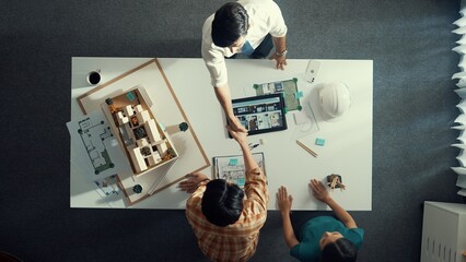 Top view of skilled architect engineer working together and shaking hand cooperative team while...