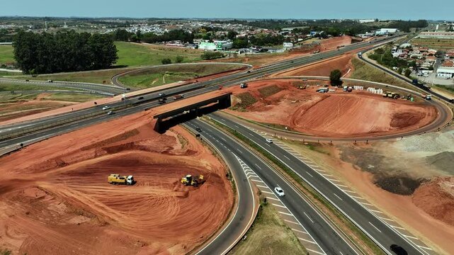 High-angle aerial view of highway infrastructure development. Construction of the access road to Shopping Botucatu, on the Teacher Joao Hipolito Martins Highway (SP-209). 10/05/2024 
