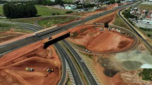 High-angle aerial view of highway infrastructure development. Construction of the access road to Shopping Botucatu, on the Teacher Joao Hipolito Martins Highway (SP-209). 10/05/2024 
