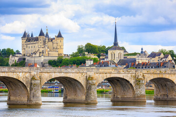 Saumur, France, located at the Loire river under a beautiful cloudscape during daytime.