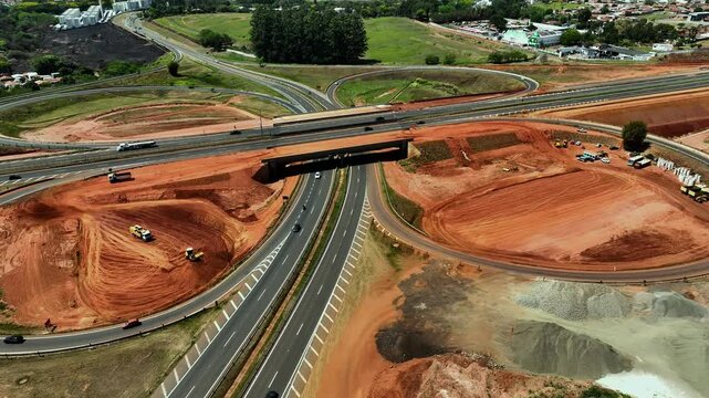 High-angle aerial view of highway infrastructure development. Construction of the access road to Shopping Botucatu, on the Teacher Joao Hipolito Martins Highway (SP-209). 10/05/2024 
