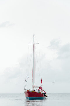 Red sailboat on the water