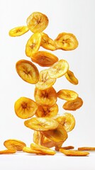Banana chips falling on a plain white background