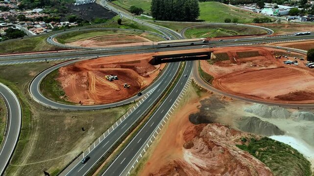 High-angle aerial view of highway infrastructure development. Construction of the access road to Shopping Botucatu, on the Teacher Joao Hipolito Martins Highway (SP-209). 10/05/2024 
