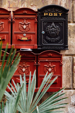 Elaborate red and black post boxes