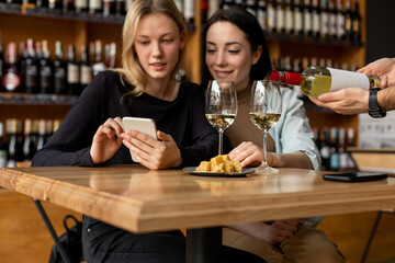 Sommelier pours wine into glasses