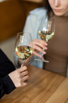 Woman's hand holds glass with wine