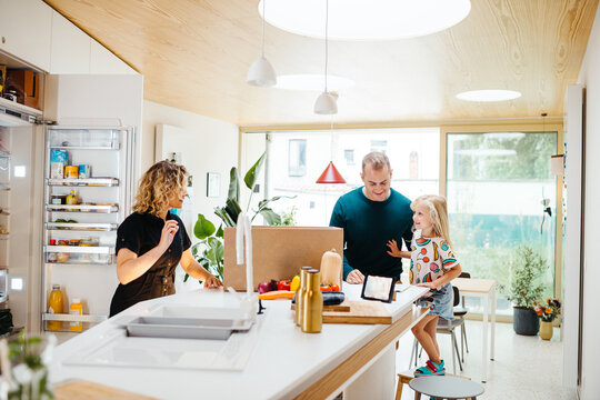 Family unpacking home delivery with groceries
