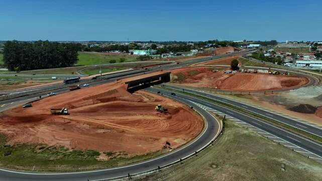 High-angle aerial view of highway infrastructure development. Construction of the access road to Shopping Botucatu, on the Teacher Joao Hipolito Martins Highway (SP-209). 10/05/2024 