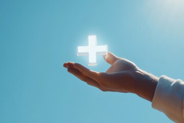 A person holds a cross in their hand, possibly as a symbol of faith or devotion
