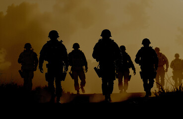 Silhouetted soldiers walking with determination against a smoky yellow background