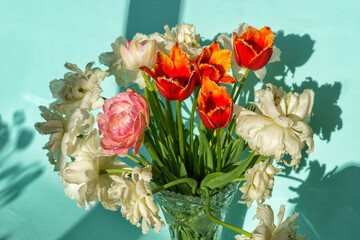 Bouquet of tulip flowers over sunny background.