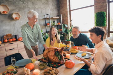 Photo of four relatives family smell serving turkey gather celebrate thanksgiving dinner apartment...