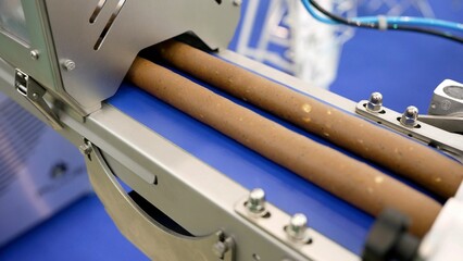 Industrial machine packaging food product.