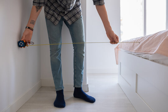 Anonymous man using measure tape