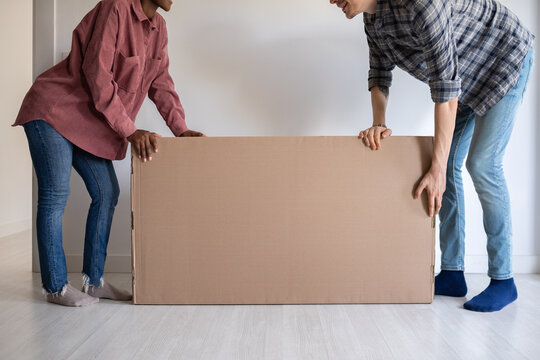 Couple holding heavy box