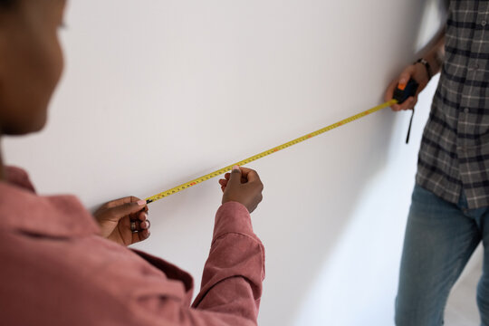 Couple using measuring tape