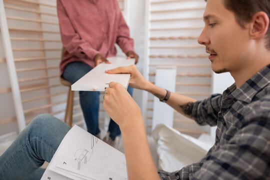 Wife helping to husband with furniture