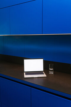 A laptop with white screen in the kitchen