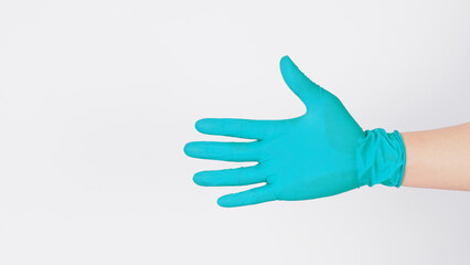 Obraz premium Hand is wearing aqua mint green latex gloves on a white background.