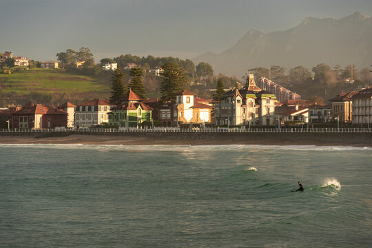 Surfer in winter wetsuit on asturian coast