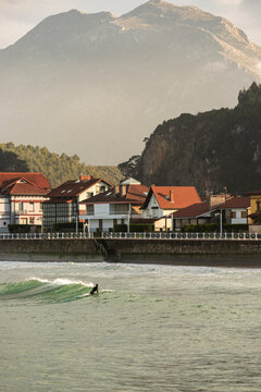 Surfer in winter wetsuit on asturian coast