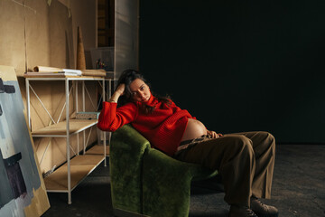 Beautiful Pregnant Woman Sitting in Studio