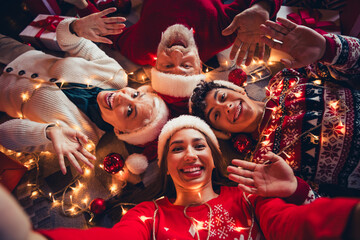 Top photo of happy smiling family lying wave hands having christmas tree decor ornament santa claus hat in house