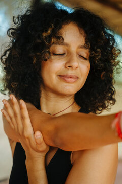 A woman stretching her right arm