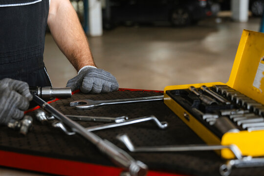A man takes a tool out of a suitcase