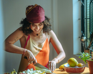 Woman Preparing a Fruit Salad in a Sunlit Kitchen