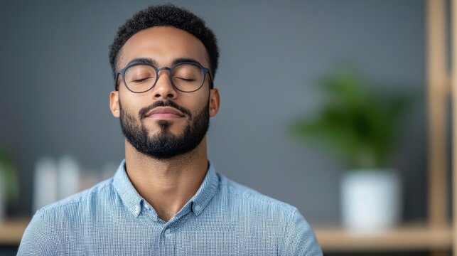 Office worker closing their eyes and practicing deep breathing, managing stress during a hectic project deadline 