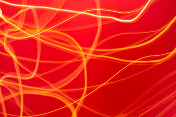 Yellow and orange light streaks with red background