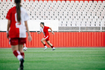  Female Football Player Sprinting After the Ball