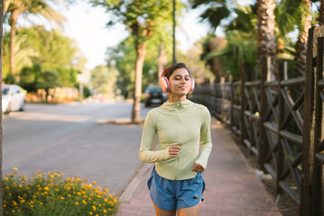 A woman is jogging energetically in a stunning and beautiful urban environment today