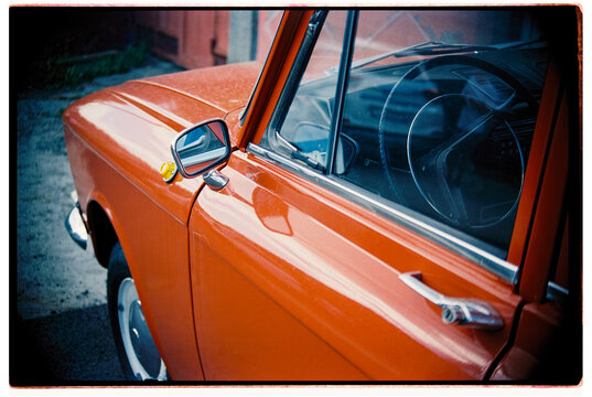 Classic Red Car Parked in Urban Setting During Daylight.