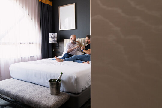 Couple Toasting in a Cozy Hotel Room