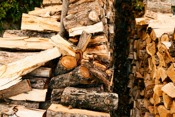 neatly stacked firewood outside rustic cabin on a cozy winter day