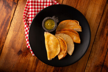 Tacos de Canasta, "basket tacos" also known as Tacos Sudados, are a typical fast food from Mexico. They are made with corn tortillas and can be filled with potatoes, beans, mole, adobo or pork rinds.