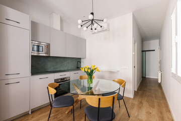 A modern kitchen with light gray cabinetry