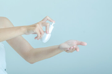 Hands Applying Skincare Product with Pump Bottle