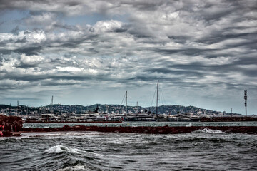 Mandelieu-La Napoule, France - September 7th 2024 : View of a part of the port of Mandelieu-La Napoule. The sea is restless, there are many waves.