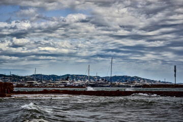 Mandelieu-La Napoule, France - September 7th 2024 : View of a part of the port of Mandelieu-La Napoule. The sea is restless, there are many waves.
