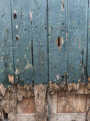 Close up of a old wooden door with peeling paint texture, background.
