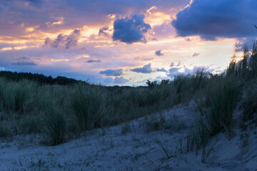 sunrise in the dunes  with blue, orange, pink and yellow colours